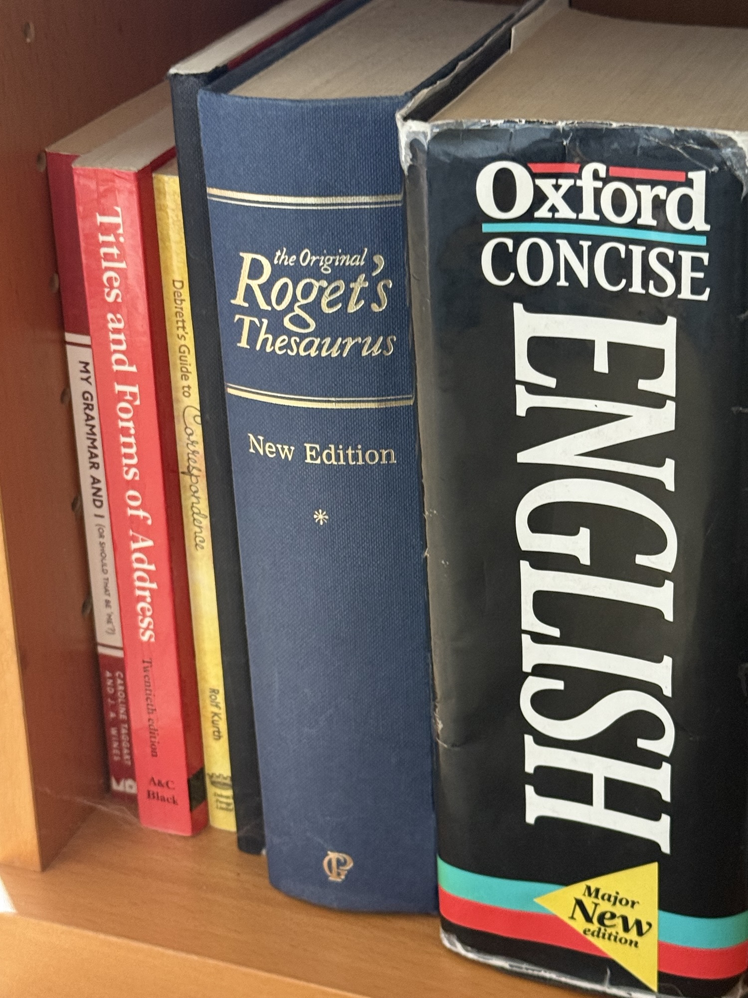 lost_for_words Book spines showing titles: My Grammar and I, Titles and Forms of Address, Debrett's Guide to Correspondence, Roget's Thesaurus New Edition, Oxford Concise English Dictionary Major New Edition