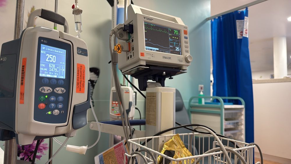 Hospital room with an infusion pump and patient monitor displaying vital signs